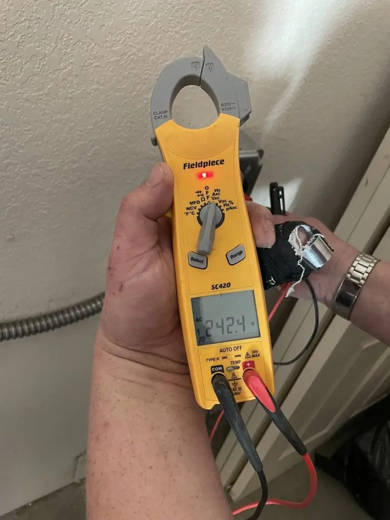 Voltage testing with clamp meter during Whole House Surge Protector in Saxon